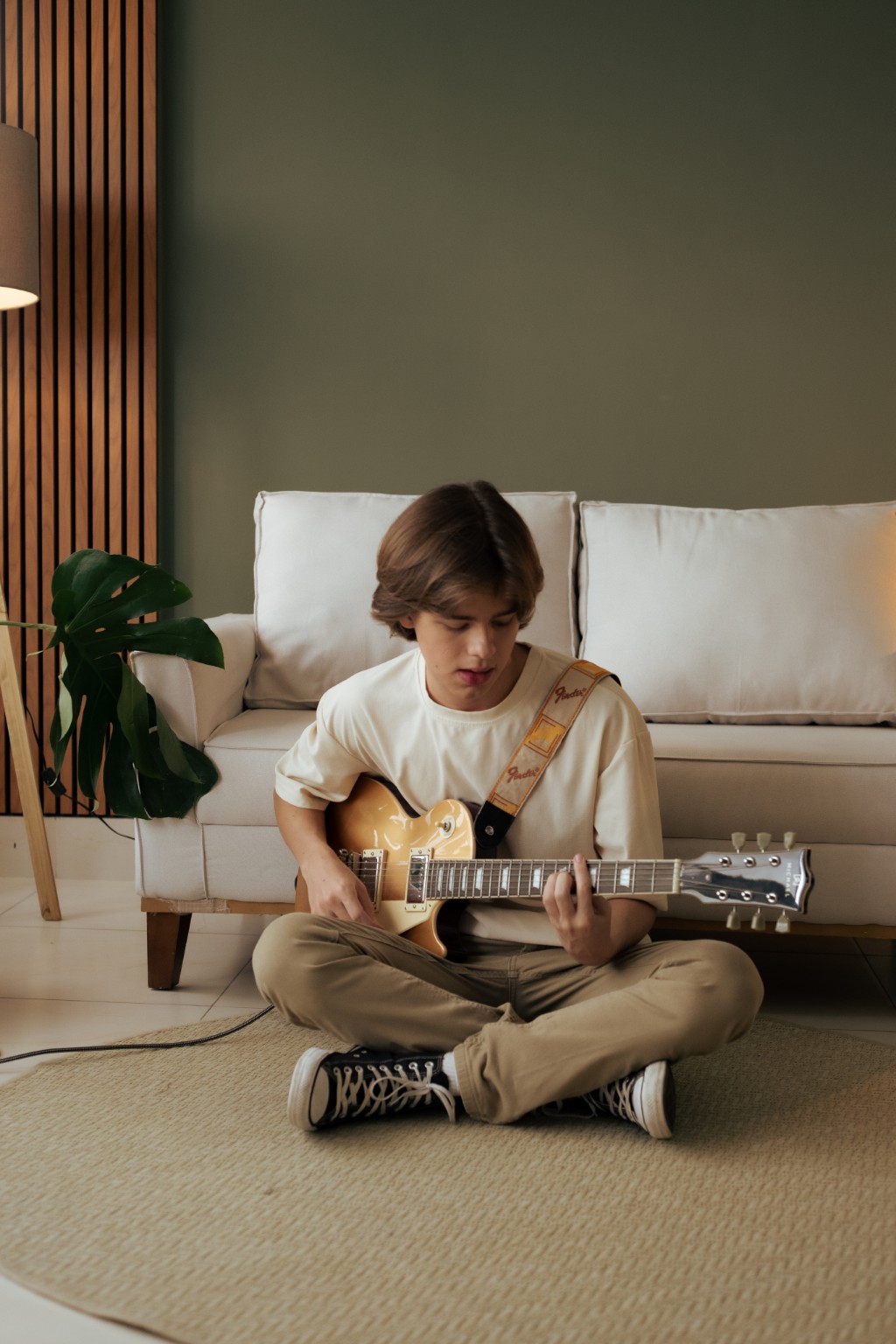 Vandoose holding a guitar